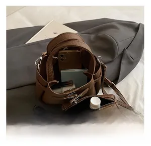 Macro view of interior storage capacity in a vintage brown leather bucket bag