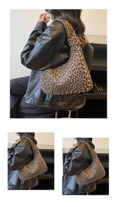 Detail of leopard print tote bag featuring silver studs and retro hobo underarm design