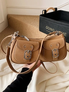 Brown vintage Y2K shoulder bag with dual metal buckle pockets and smooth leather finish