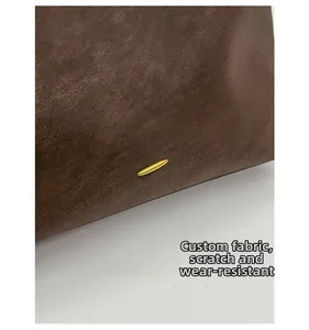 Detail of dark brown leather texture with gold metal clasp showing scratch resistant fabric