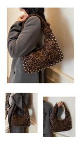 Detail of leopard print tote bag featuring silver studs and velvet texture on a shoulder strap