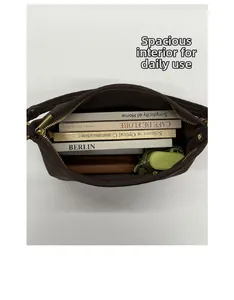 Top view of large capacity dark brown baguette bag showing books, wallet and folding umbrella