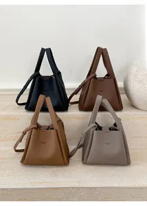 Detailed display of vintage bucket tote bags in black, brown, camel and grey textured leather