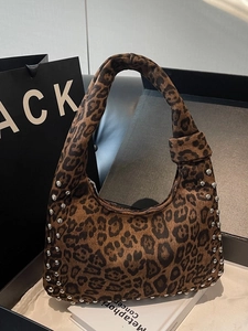 Leopard print hobo bag with silver rivets and knotted strap in a 45-degree side view