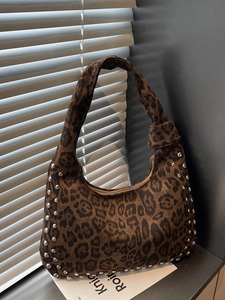 Brown leopard print hobo bag with silver studs and knotted strap for daily commuting