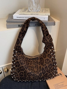 Large leopard print hobo bag with silver rivets and vintage shoulder strap design