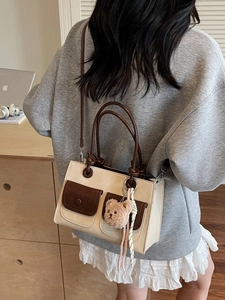 Chic 2025 winter leather tote bag in beige and brown contrast with bear charm
