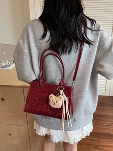 Winter style dark red faux leather tote bag with plush bear charm and adjustable strap
