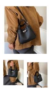 Detail of black lychee grain leather bucket bag with silver twist lock and strap
