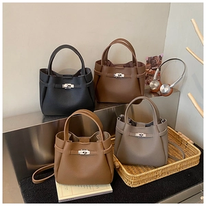 Four elegant lychee grain leather bucket bags featuring metallic turn-lock closures and straps