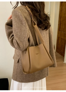 Detailed view of brown lychee grain leather bucket bag with House & Bags Fashion logo