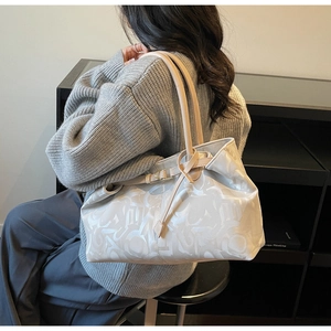 Side view of beige leopard pattern tote bag on model for casual commuting style
