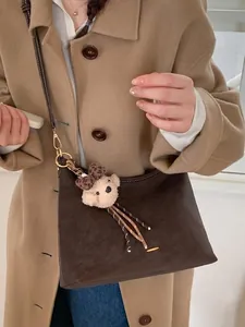 Retro chocolate brown hobo shoulder bag with a cute plush bear charm for women