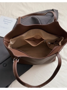 Top view of brown lychee-pattern tote bag showing spacious interior with zipper pocket