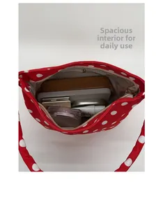 Interior view of red polka dot canvas bag showing large capacity and zipper pocket
