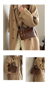 Detail of vintage brown bucket bag with decorative wooden beads and smooth leather texture
