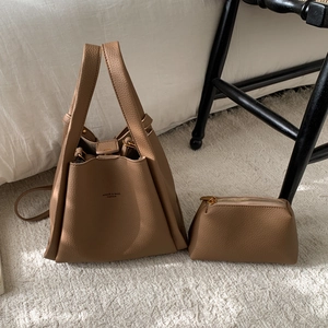 Detail of caramel brown litchi pattern leather bucket bag set with inner zipper pouch