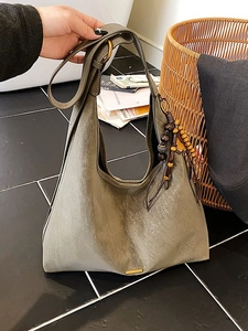Vintage sage green leather hobo bag with bohemian wooden beads and brass ring detail