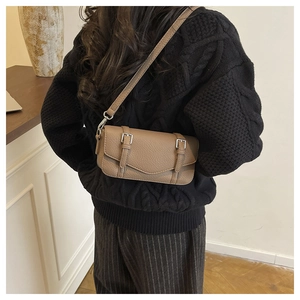 Brown pebbled leather satchel bag worn on the back with adjustable shoulder straps