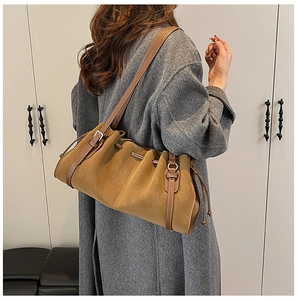 Detail of vintage khaki shoulder bag with stylish drawstring and adjustable side buckle