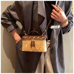 Detail of color-block quilted box bag with brown leather and khaki suede texture