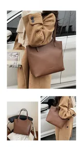 Close-up of brown litchi pattern leather tote bag with elegant shoulder straps