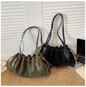 Detail of oversized ruched tote bags in olive green and black matte faux suede