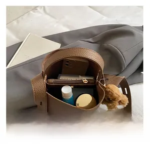 Interior view of brown lychee grain bucket bag showing spacious storage for daily items