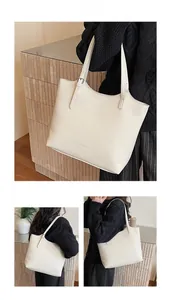Three-view shots of cream leather tote bag featuring adjustable strap and pebble grain
