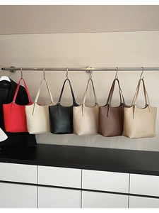 Detailed display of assorted pebble grain leather tote bags hanging on a display rack