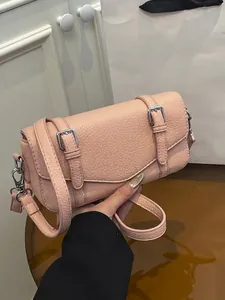 Pink lychee grain leather messenger bag with silver buckles and a detachable strap