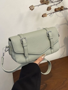 Elegant mint green satchel bag in litchi grain leather with decorative buckles