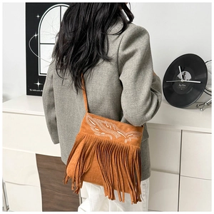 Detailed back view of a brown suede tassel shoulder bag with white feather embroidery