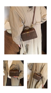 Detail view of brown quilted crossbody bag with gold hardware and suede texture