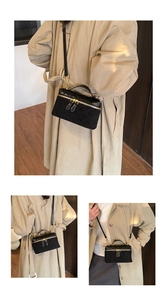 Close-up of black quilted box bag with gold hardware and elegant chain strap detail