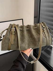 Vintage olive green suede drawstring hobo bag with buckled straps and silver hardware