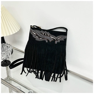 Close-up of bohemian black suede bucket bag featuring intricate silver leaf embroidery