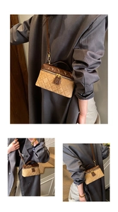 Close-up of quilted contrast panels and metal zipper on this vintage chain bag