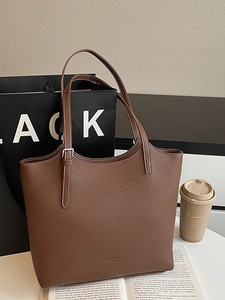 Brown lychee leather tote bag with white contrast stitching and adjustable strap details