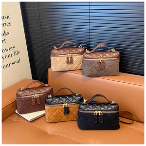 Detailed overhead view of quilted leather handbags in various vintage earth tone colors