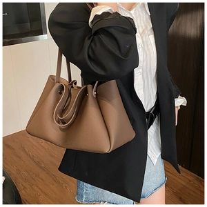 Detailed macro shot of deep brown pebble grain leather on a large tote bag for women