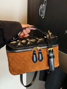 Quilted black and brown crossbody bag with dual zipper and adjustable leather strap
