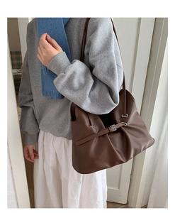 Detailed view of dark brown pleated tote bag with silver buckle and faux leather texture