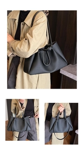 Detail of black lychee grain tote bag showing multiple ways to wear and rivet accents