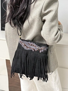 Chic black faux suede crossbody bag with feather embroidery and long boho fringes