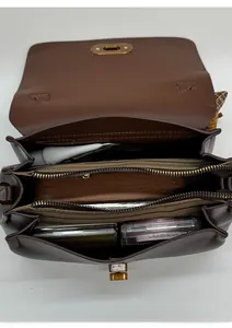 Internal view of brown faux suede bag showing multiple compartments and large capacity