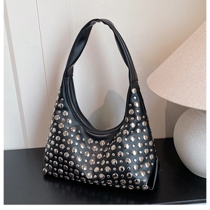 Detail of black hobo bag with silver metallic studs and smooth zipper closure