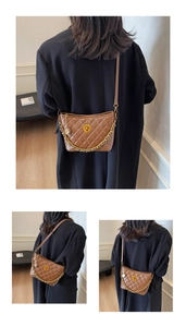 Detailed close-up of brown quilted faux leather shoulder bag with gold chain and turn-lock