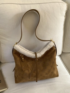 Brown suede tote bag with white faux fur trim and embossed geometric floral patterns