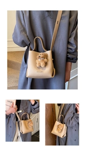 Detailed macro view of beige bucket bag with lychee texture and cute bear pendant charm